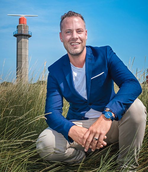 Michaël from Apollo Digital, in the dunes near a lighthouse